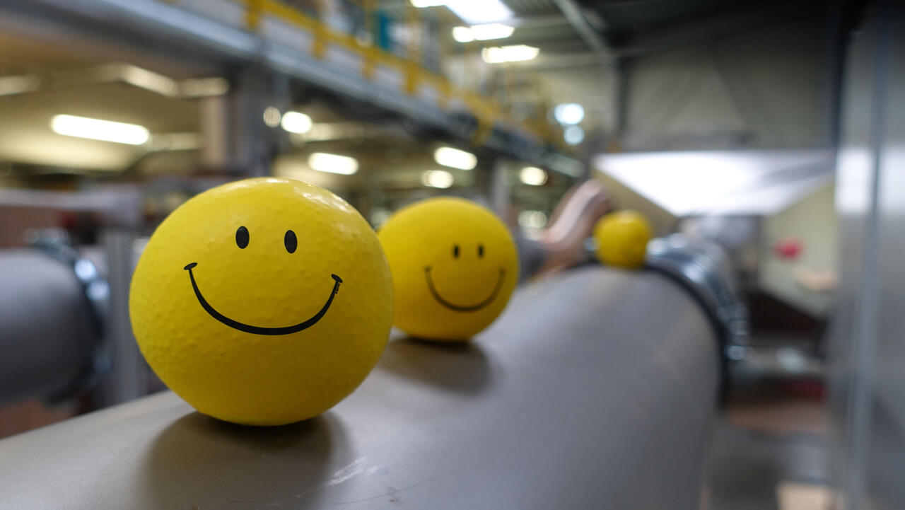 Production hall with yellow smiley balls on test channel