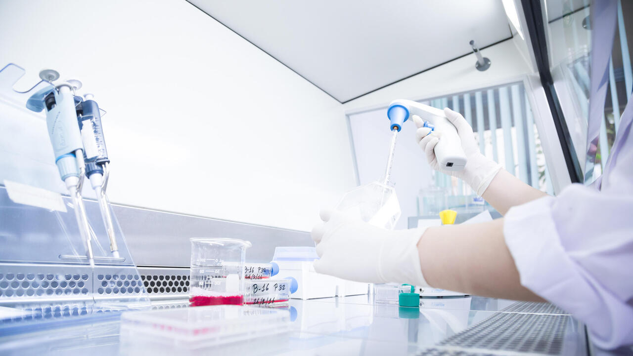 Scientists in the cleanroom (glove box) filling with pipettes