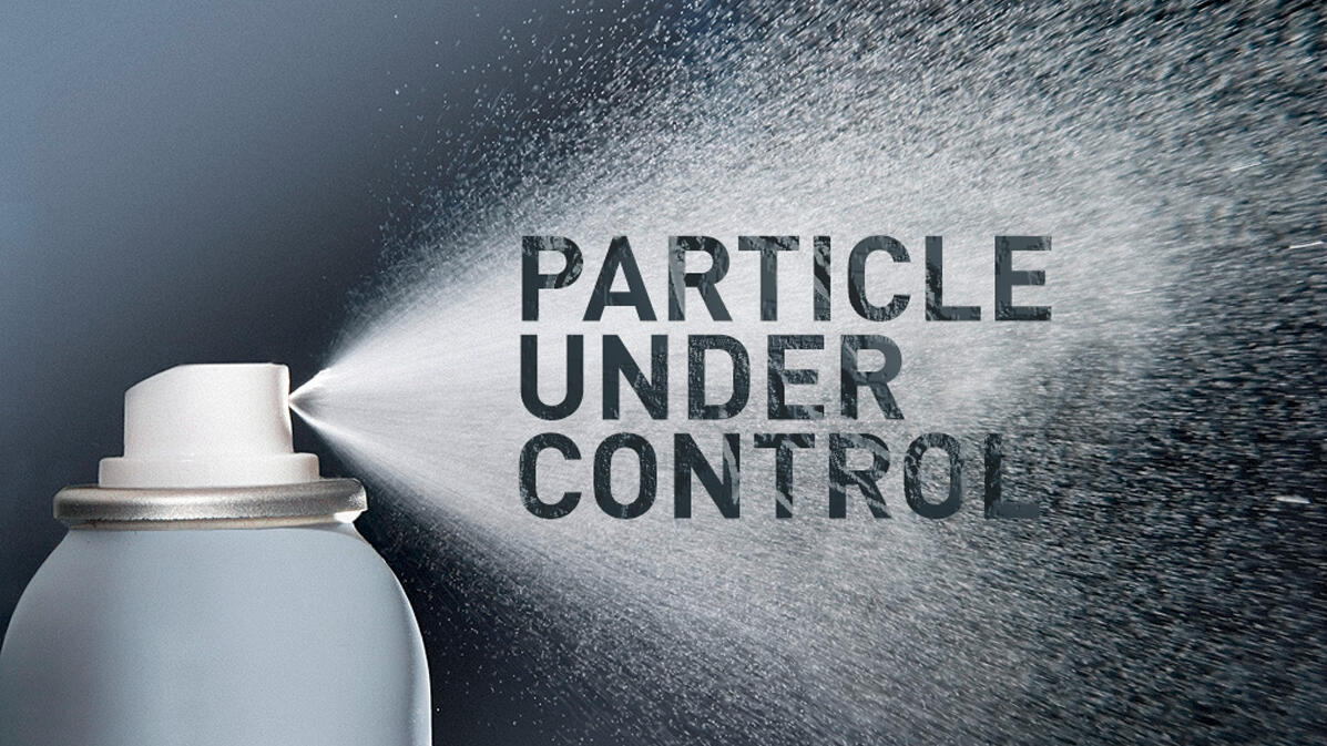 Spray bottle with mist, motto "Particle under control" in it