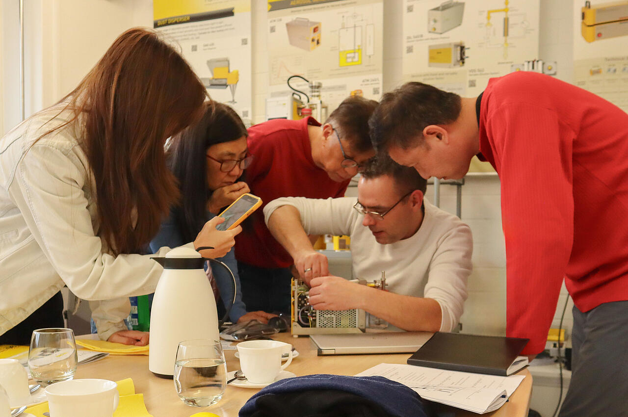 People looking at a Topas device