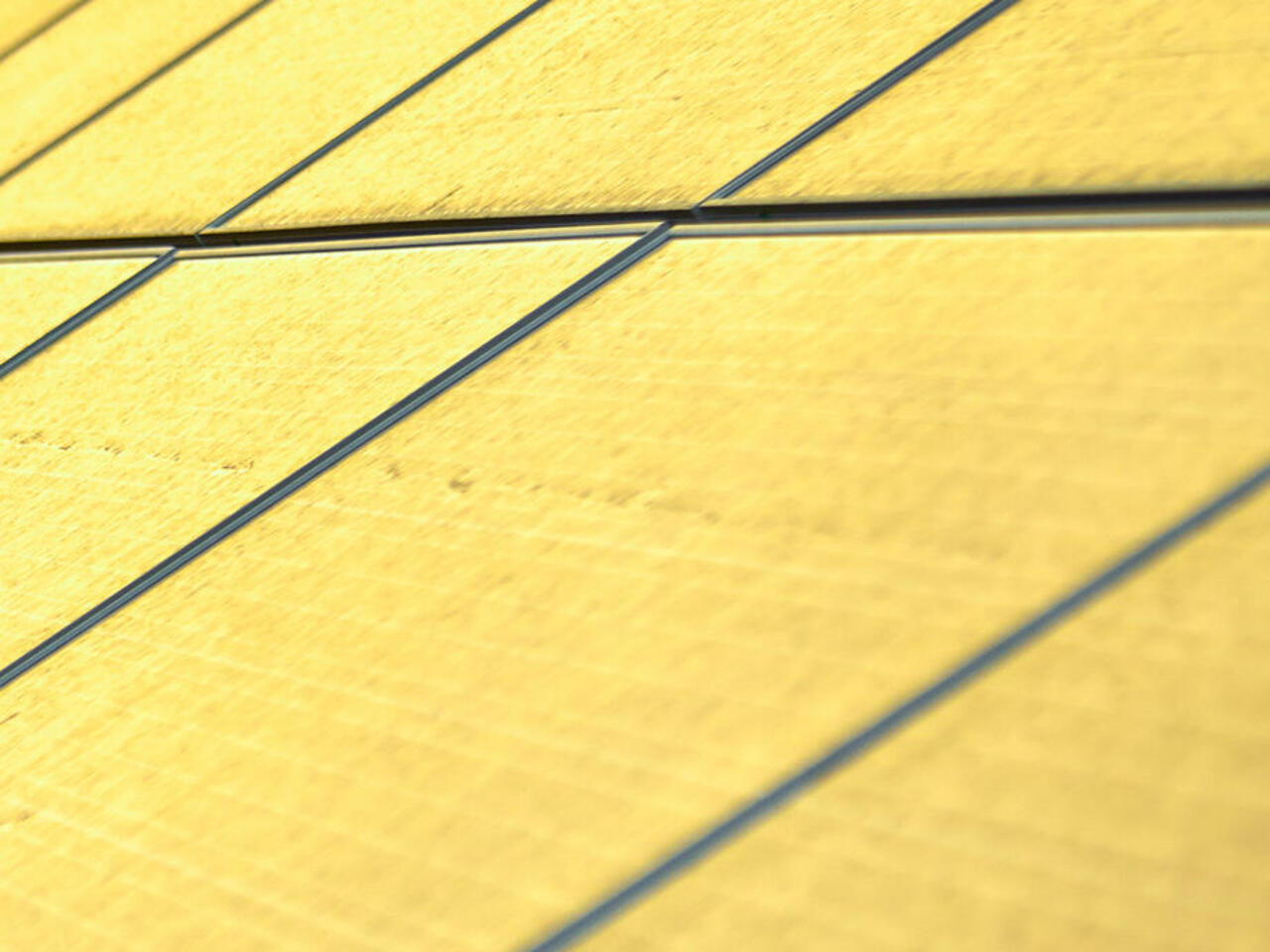 Engineer tests photovoltaic system in desert against yellow sky